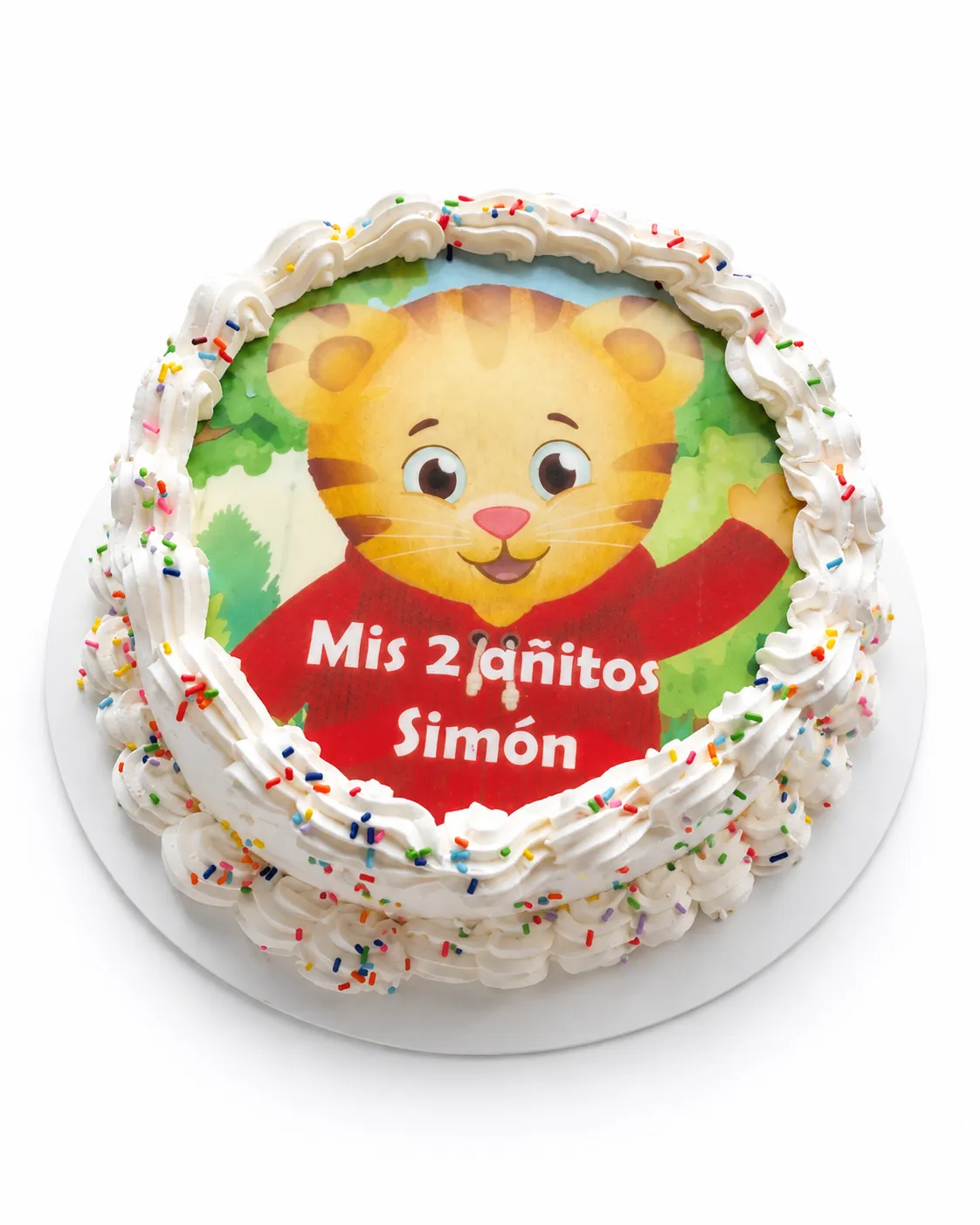Torta con foto comestible de un tigre de dibujitos y la frase «Mis 2 añitos Simón», con borde de merengue y chispas de colores.