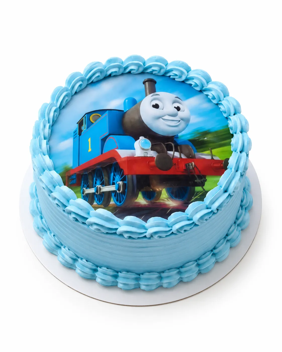 La misma torta de la locomotora azul, vista de frente con su borde de merengue celeste.