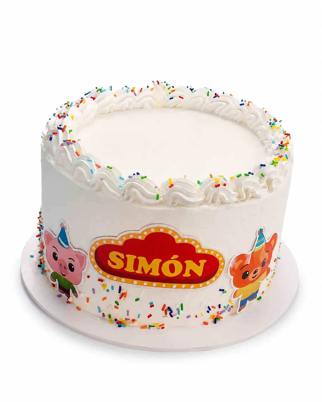 Torta blanca con chispas de colores, muñequitos de fiesta y un cartel con el nombre Simón.